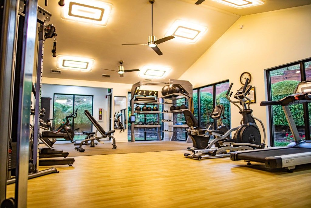 A gym with treadmills, stationary bikes, and weight machines.