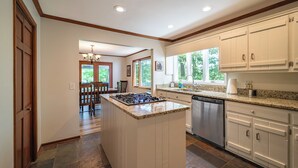A kitchen with a central island, built-in appliances, and a view of the outdoors. - 4BR Lake House w/ Private Dock, Hot tub, and Lake Views! (Blairsville)