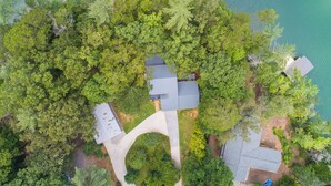 An aerial view of a property with multiple buildings surrounded by dense greenery and a body of water. - 4BR Lake House w/ Private Dock, Hot tub, and Lake Views! (Blairsville)
