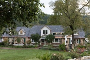 Traditional building with a Truman Cafe & Restaurant sign, surrounded by a well-maintained lawn and lush greenery.