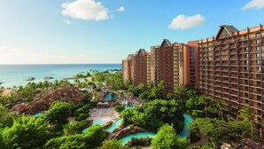 A resort with multiple high-rise buildings, a pool area, and a view of the ocean. - Ko Olina | Romantic Disney Retreat | Lagoon + Pool (Kapolei)