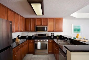 Enjoy cooking in this well-equipped kitchen with a microwave, oven, and sink.