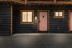 Three doors lead to this charming building, each with a small window above.