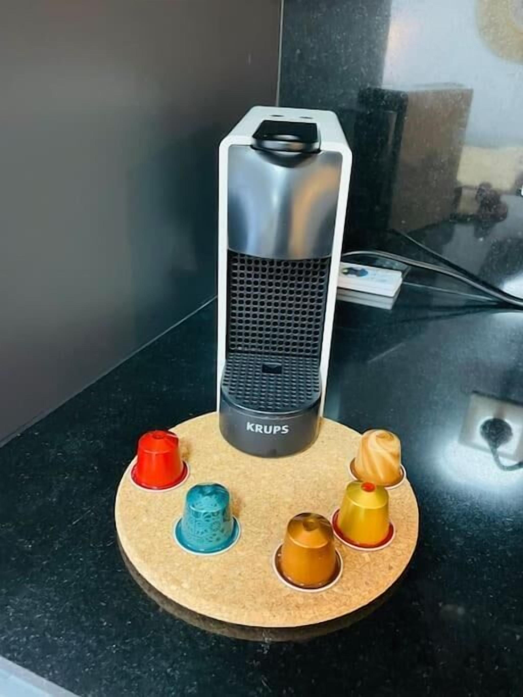 A Krups portable heater on a round wooden base with five colorful cups.