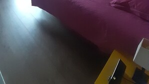 A bedroom with a bed, a lamp, a desk, and a window with curtains. - Maison Chaleureuse Avec Piscine Entre Montagne ET MER (ASCAIN)
