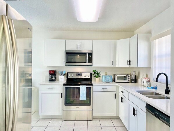 Enjoy cooking in this well-equipped kitchen with a microwave, oven, toaster, and dishwasher.