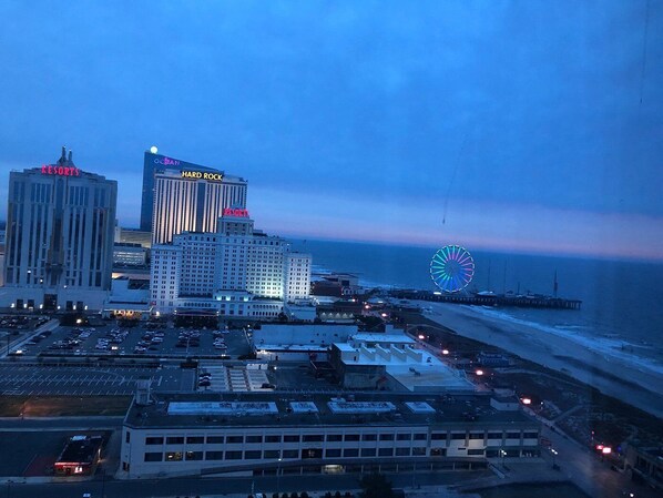 A large hotel with multiple buildings, a prominent Ferris wheel, and a beach in the background.