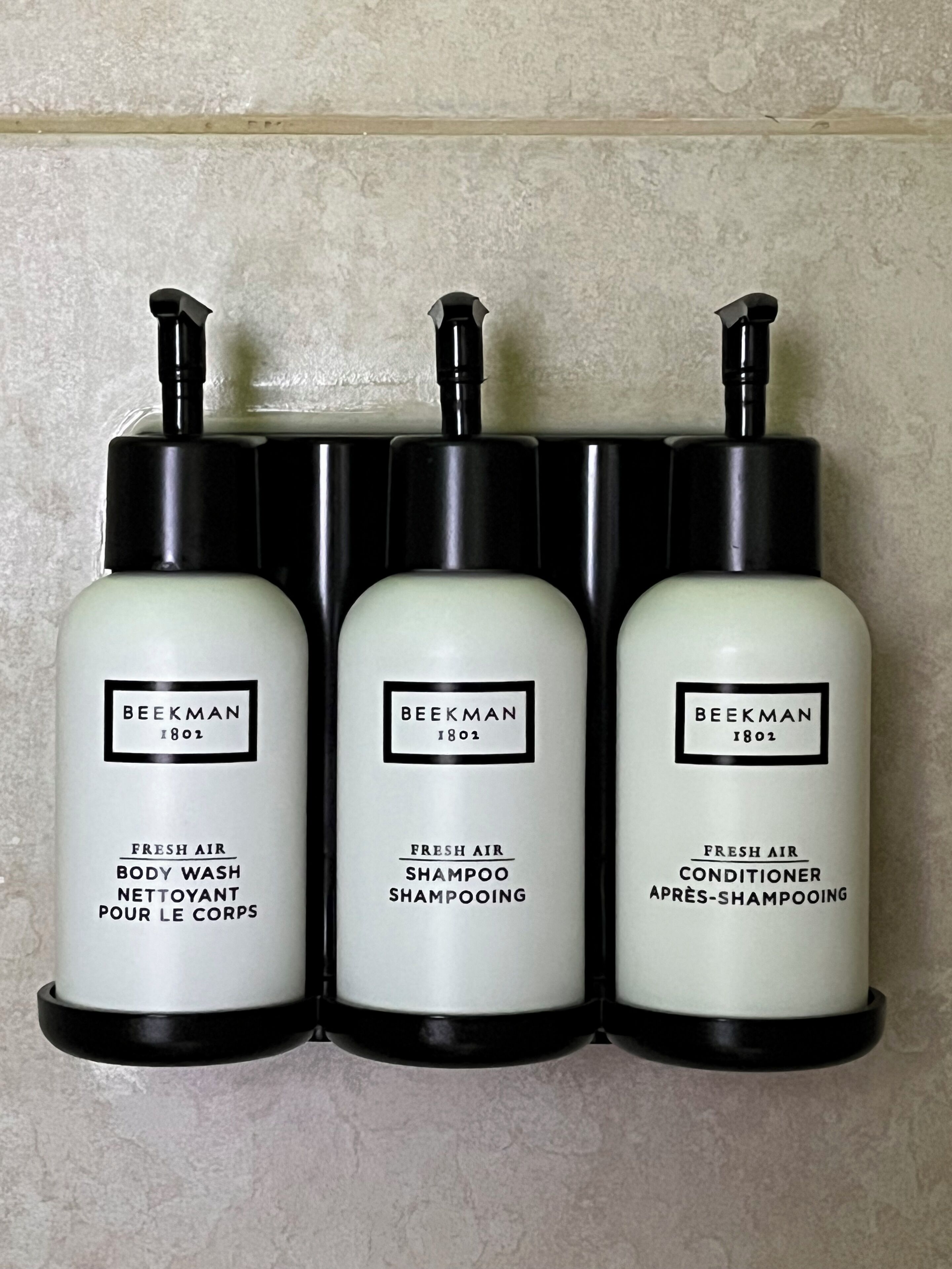 Three bottles of Beekman 1802 fresh air body wash, shampoo, and conditioner.