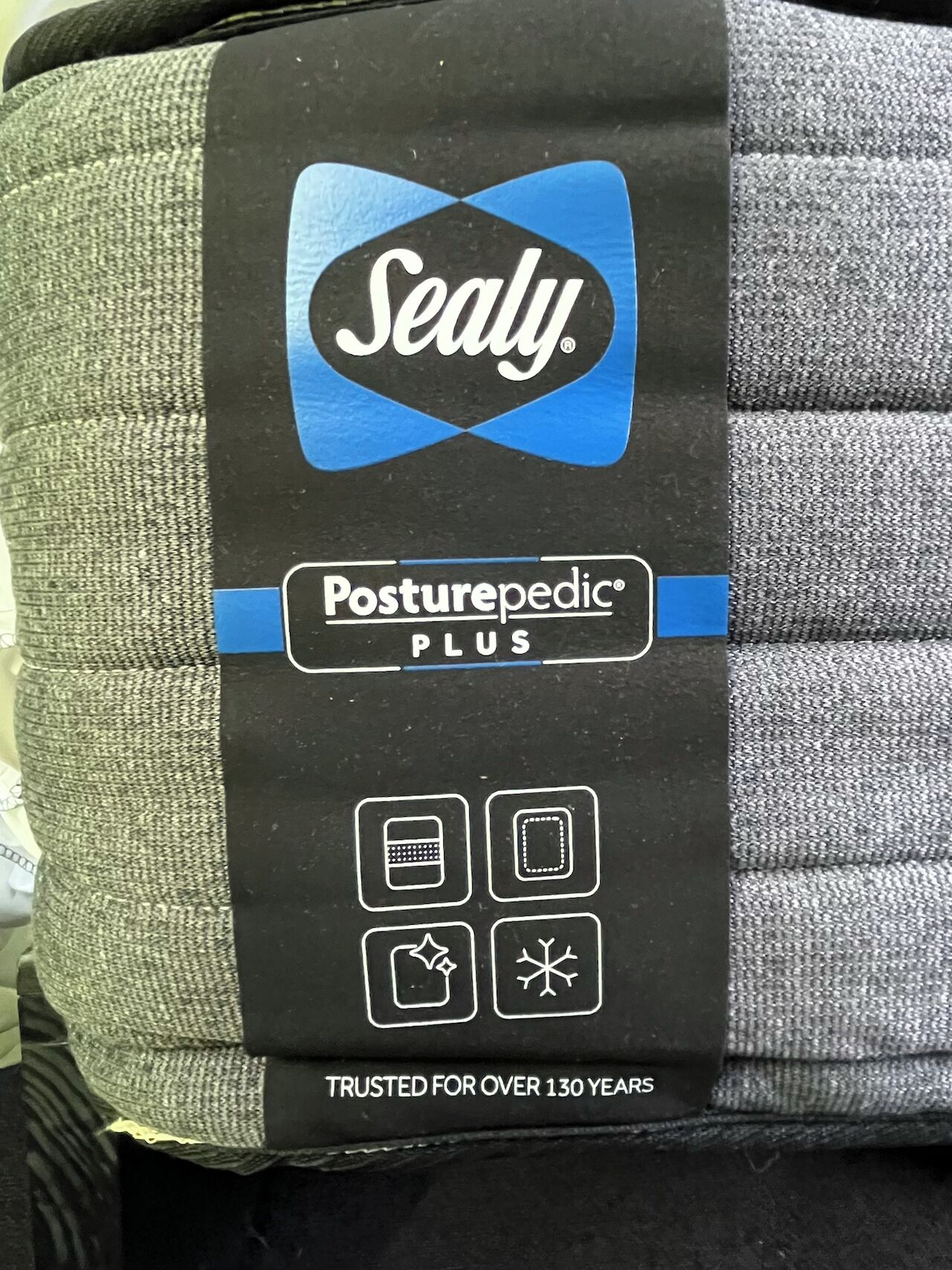 A package of Sealy Posturepedic PLUS bedding.