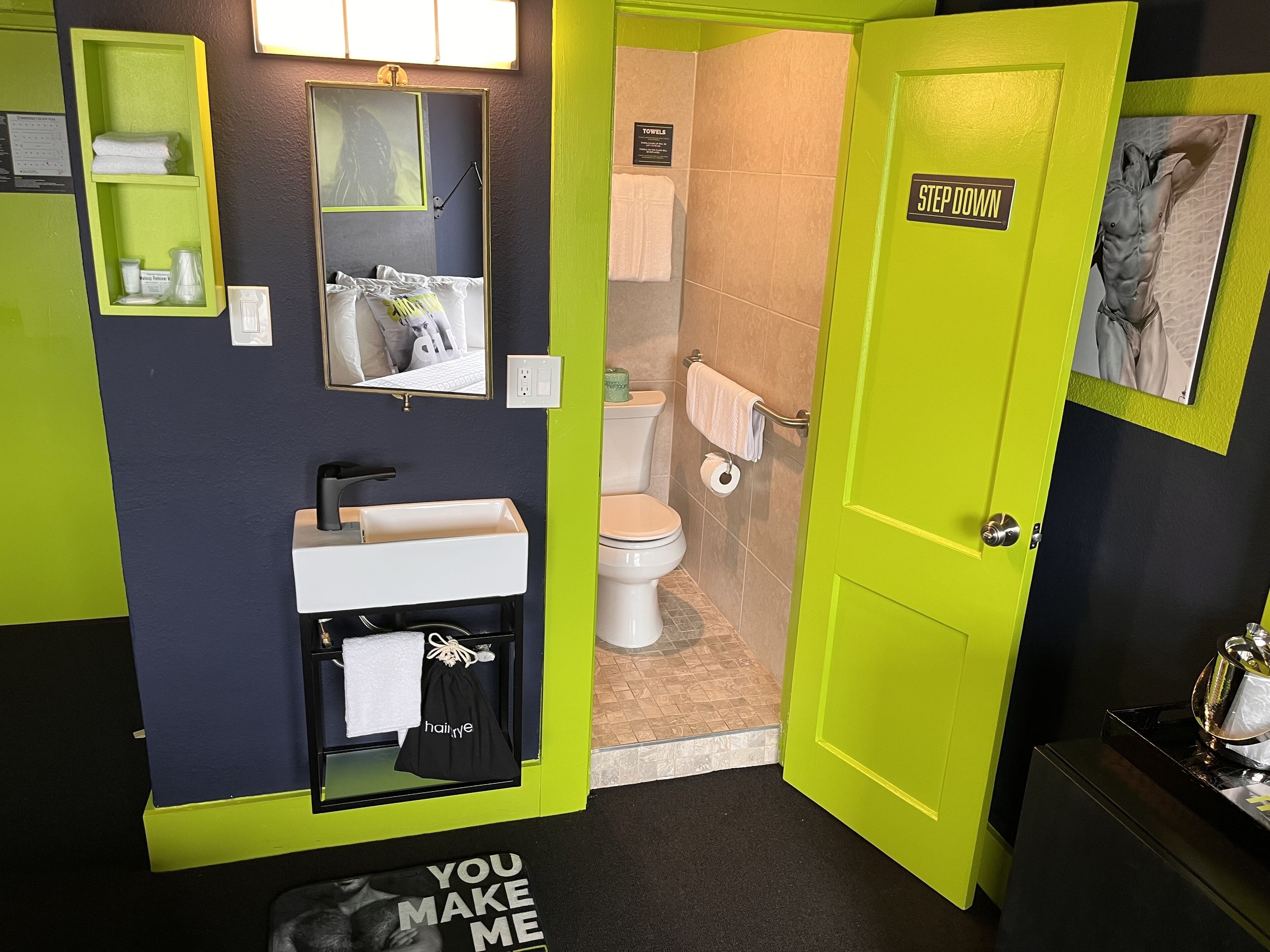 A bathroom with a sink, mirror, towel rack, and toilet.