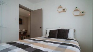 Ein Schlafzimmer mit einem Bett, einem Schreibtisch und zwei sechseckigen Wanddekorationen.
