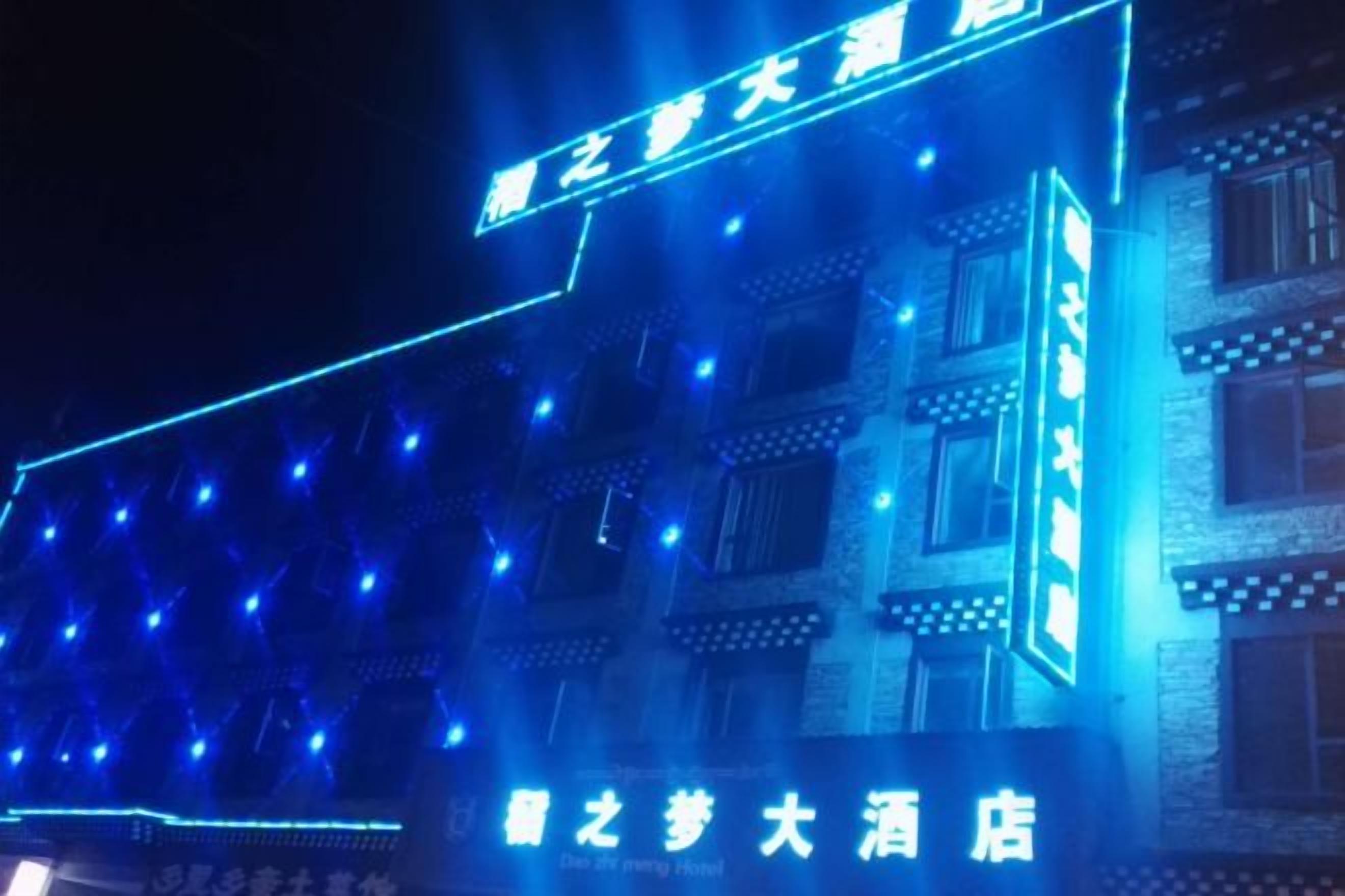 A building with illuminated signage and multiple windows.