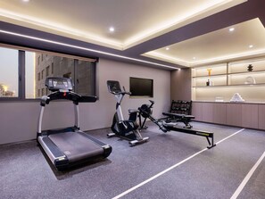 A modern gym with treadmills, stationary bikes, and a rowing machine. - Novotel Wuxi Sanyang Plaza (Wuxi)