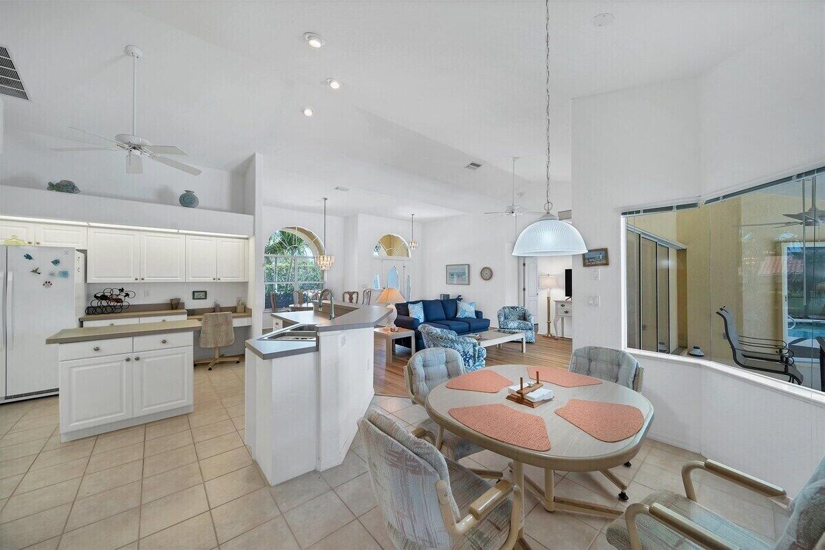 A spacious living area with a kitchen, dining table, and seating.