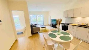 A modern apartment with a dining area, kitchen, and living room. - Luxury 2023 Flat in city center. Parking (Luxembourg City)