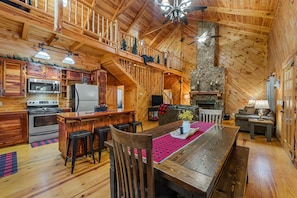 A spacious wooden cabin with a kitchen, dining area, and a fireplace. - Lazy Bear-hot tub, fire pit, foosball, ping pong, air hockey (Mentone)
