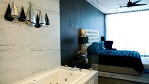 A modern bathroom with a bathtub, a mirror, and a ceiling fan. - Amazing brand new 2BD/2Bath Penthouse Condo overlooking the beach. (Puerto Peñasco)