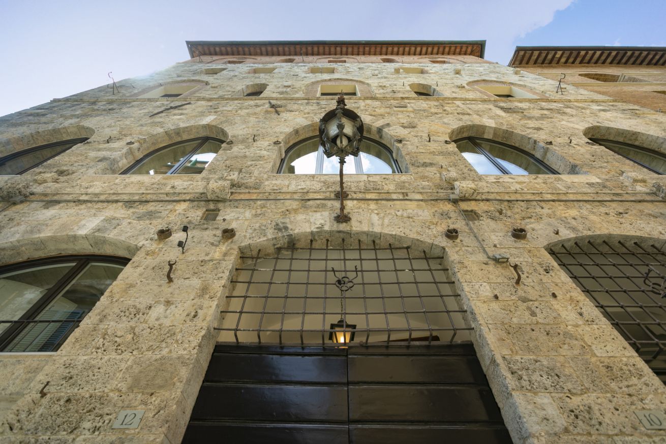 A stone building with arched windows and a central entrance.