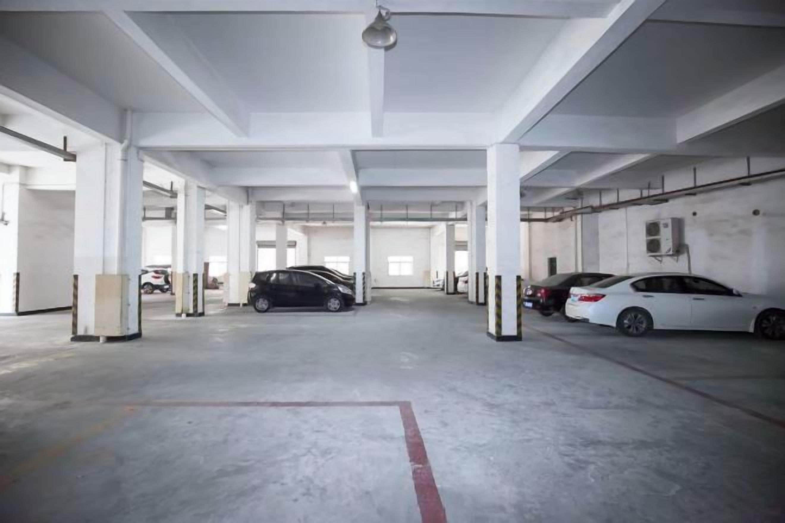 A multi-level parking garage with several cars parked.