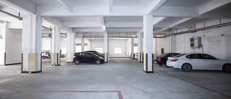A multi-level parking garage with several cars parked.