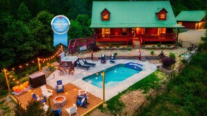 A lodge with a hot tub, outdoor seating, and a swimming pool. - Private*Pool*HotTub*Sauna*FirePit*Theater+GameRoom (Sevierville)