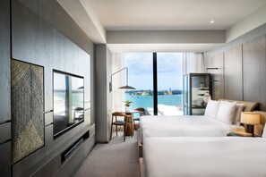 A modern hotel room with two beds, a TV, and a view of the sea. - InterContinental Auckland by IHG (Auckland)