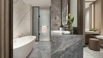 A modern bathroom with a freestanding bathtub, a glass-enclosed shower, and a vanity with a mirror.