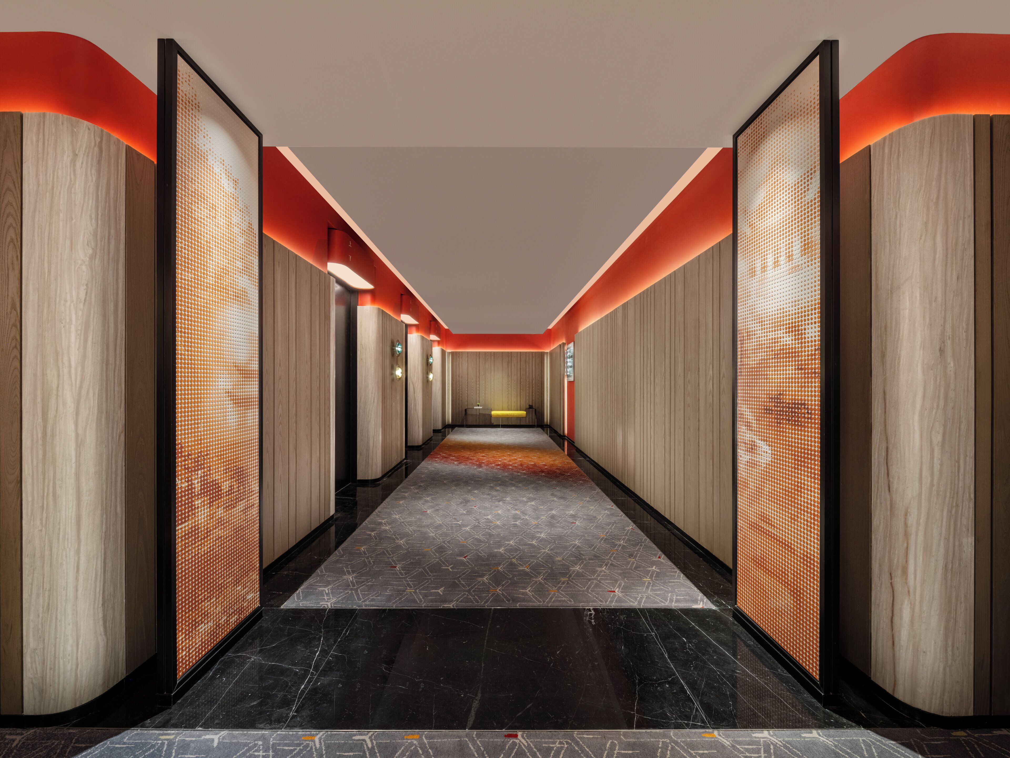 A modern hallway with wooden paneling, a patterned carpet, and a black marble floor.