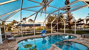 Ein Poolbereich mit überdachtem Bereich, Liegestühlen und einem schwimmenden Ring.