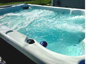Relax in a spacious hot tub with jets for a soothing experience.