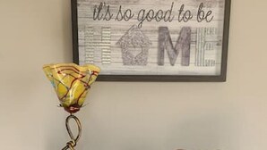A wooden shelf with a clock, a small plant, and a decorative sign. - Amazing 3 bedroom home, perfect for families! (Glendale)