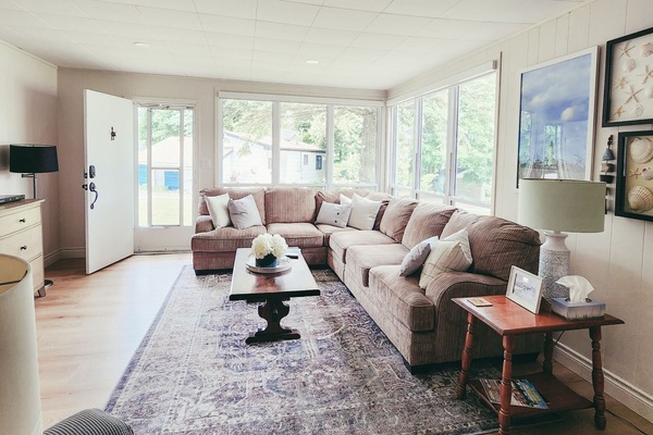 Relax and unwind: TV and sectional couch in cozy living room.
