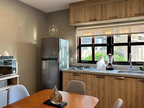 Fridge, stovetop, dishwasher, coffee/tea maker