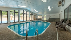 An indoor swimming pool with clear glass walls, a tiled floor, and a ceiling with skylights. - New Build 3BR Branson Condo w/ Arcade + Indoor Pool | FH G-303 (Branson)