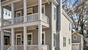 A two-story house with a front porch, a chimney, and a garage. - The Yak Shack: Carriage House in Historic District - 4 blocks from Riverwalk (Wilmington)