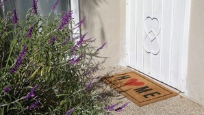 A white door with a heart-shaped keyhole and a doormat with "I ♥ ME" written on it. - Bright and Charming Guest House (10 mins from LAX) (Los Angeles)