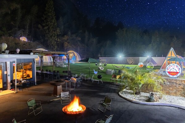 Relax in our outdoor patio, featuring a central fire feature and comfortable seating areas.