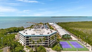 A multi-story hotel with a rooftop pool, tennis courts, and a view of the ocean. - Overlooking The Marina and Ocean (Key Largo)