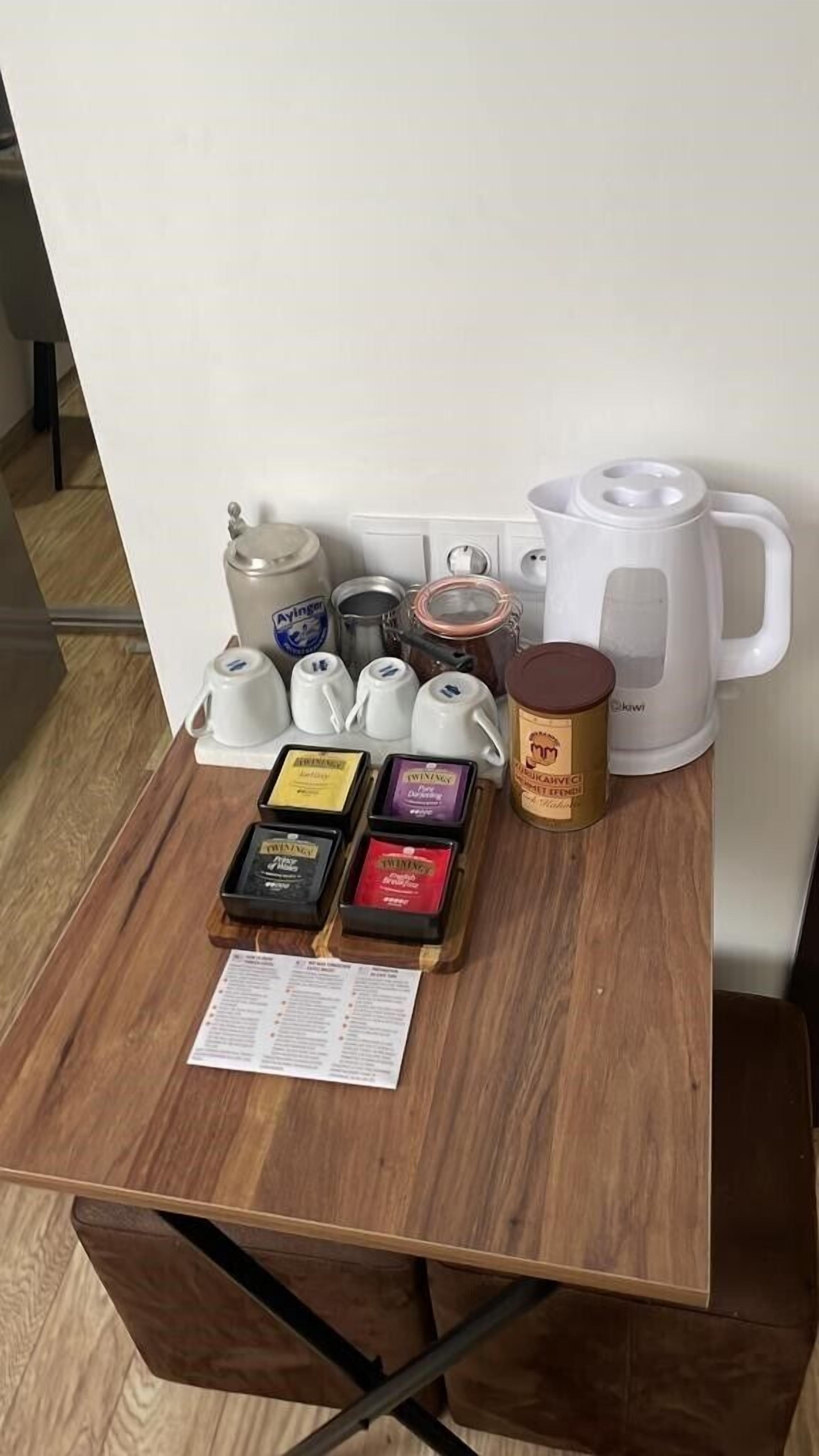 A coffee station with multiple coffee makers, a coffee grinder, and a menu.