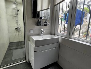 Shower, hair dryer, towels, shampoo