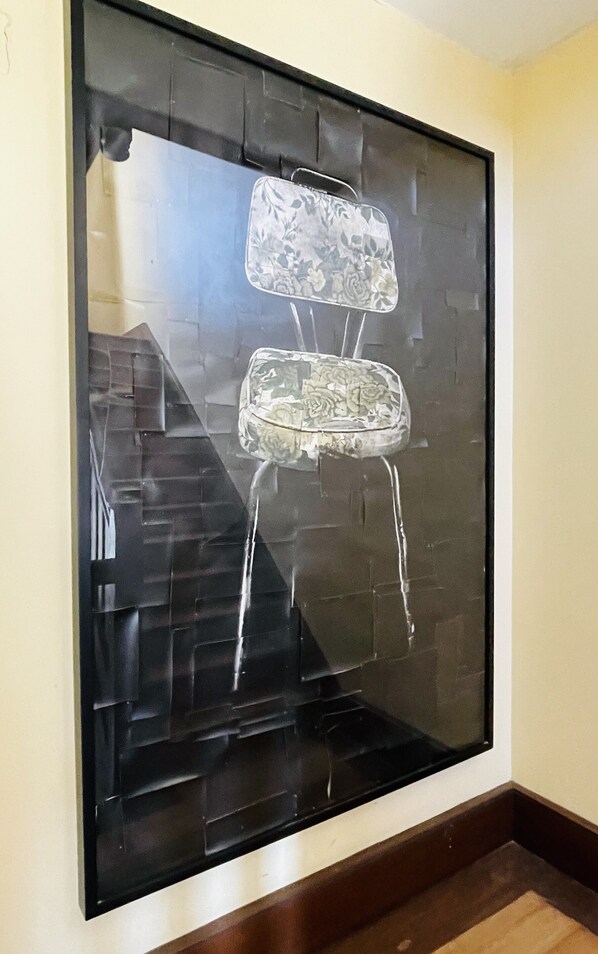 A large mirror reflects the staircase and a textured wall.