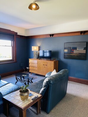 Relax in this stylish living room with a sofa, coffee table, and flat-screen TV.