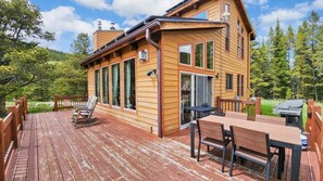 Enjoy a meal on the deck with a view of the surrounding forest from the dining area.