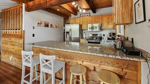 Enjoy cooking in this well-equipped kitchen with a central island and stainless steel appliances.