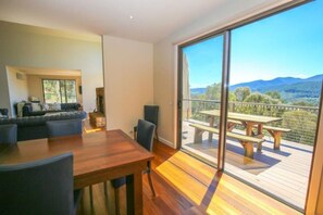 Enjoy a meal on the outdoor deck with a view of the surrounding landscape, or relax in the room with a sofa and dining table.