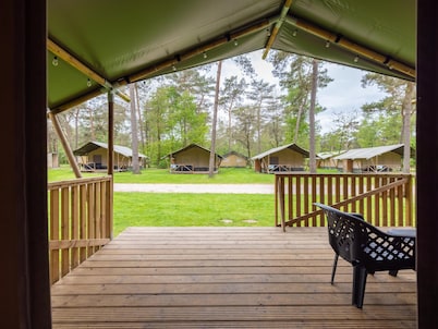 Glamping tent on campsite with swimming pool