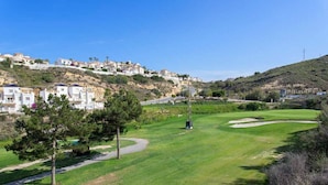 A golf course with a clear path, a flagstick, and a view of hillside buildings. - CH Villa San Miguel La Marquesa Golf (Ciudad Quesada) (Ciudad Quesada)