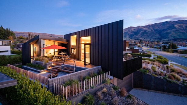 A modern house with a patio, outdoor seating, and a view of mountains. - Hideaway on Warren Wanaka (Wanaka)