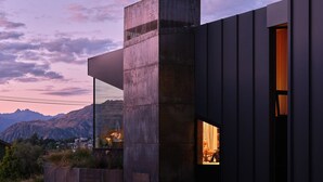A modern building with a prominent concrete structure and a large window. - Hideaway on Warren Wanaka (Wanaka)