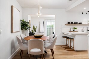 Enjoy meals in the kitchen and dining area, featuring a sink, wooden island, and round dining table.